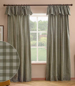 Harriet green and cream gingham check fully lined curtains with gathered ruffle flop-top headers, framing a large window in a living room.