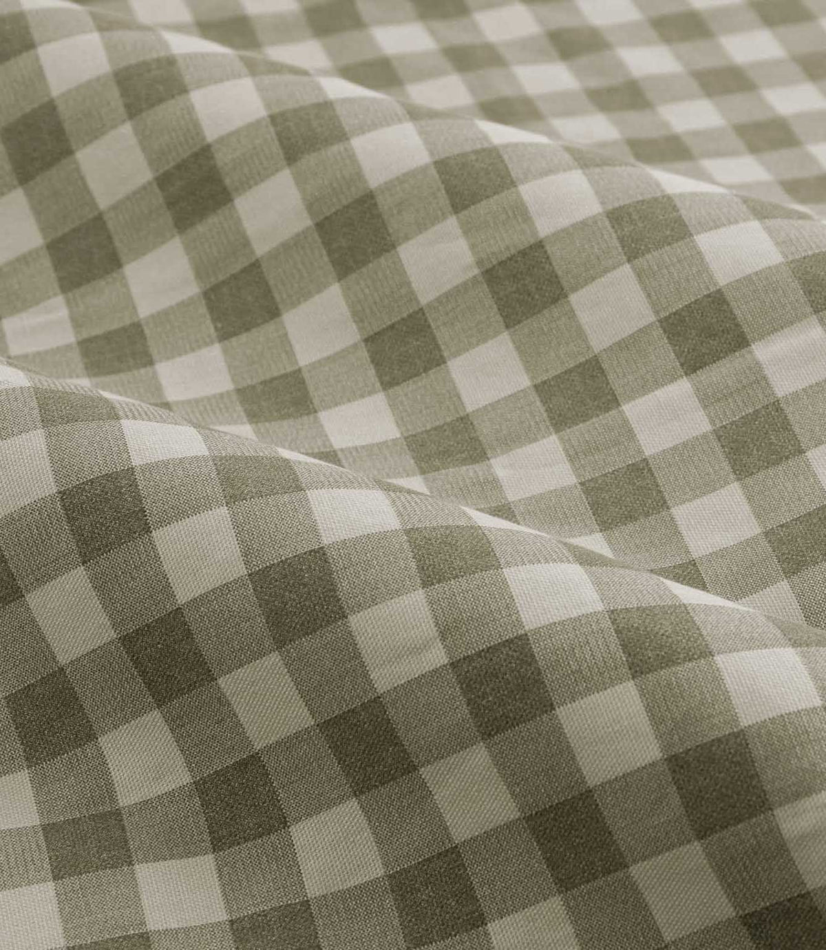 A close-up of draped fabric with a classic gingham check pattern in sage green and off-white.