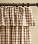 Harriet natural beige and cream gingham check fully lined curtain with a gathered ruffle flop-top header, shown hanging from a dark wooden curtain pole.