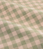 Close-up detail of Harriet pink and sage green gingham check fabric arranged in soft folds, showing the woven texture and classic checked design.