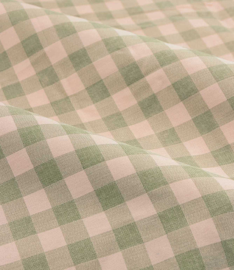 Close-up detail of Harriet pink and sage green gingham check fabric arranged in soft folds, showing the woven texture and classic checked design.