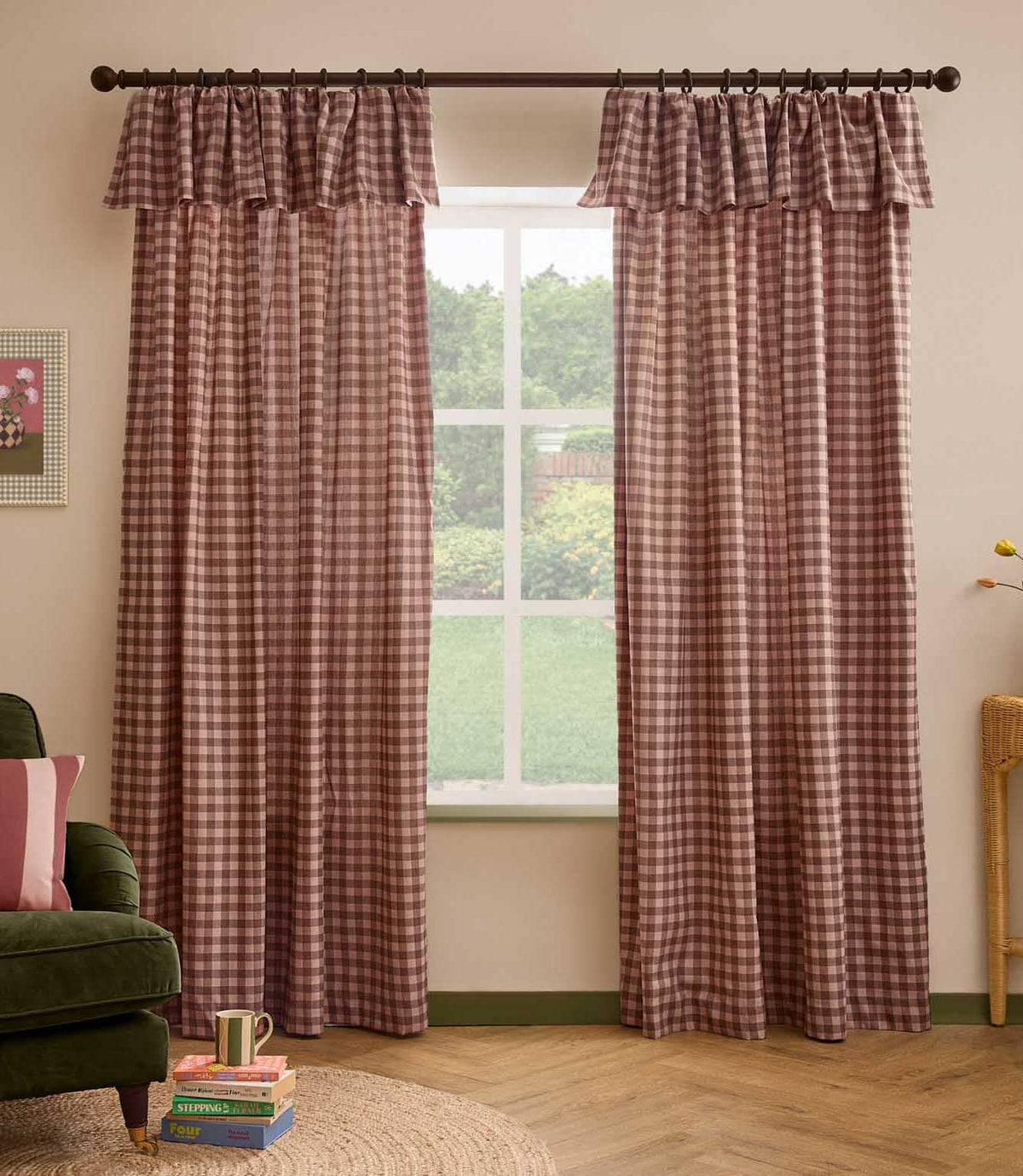 Pair of Harriet pink and brown gingham check fully lined curtains with gathered ruffle flop-top headers, framing a large window in a relaxed living room.