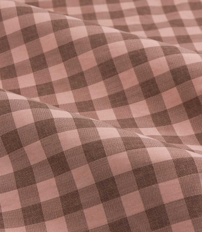 Close-up detail of Harriet pink and brown gingham check fabric arranged in soft folds, showing the woven texture and evenly spaced checked design.