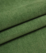 Folded emerald green woven upholstery fabric showcasing the soft texture and durable construction of Hartwell.