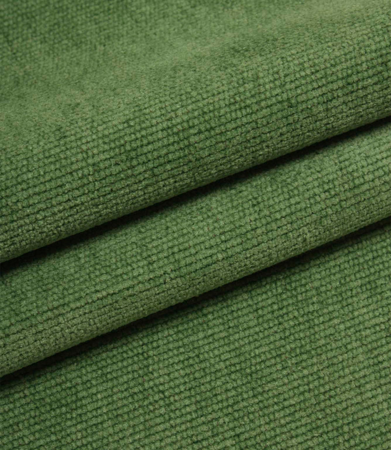 Folded emerald green woven upholstery fabric showcasing the soft texture and durable construction of Hartwell.