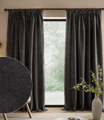 Charcoal grey Heath washed velvet pencil pleat curtains frame a large window, with an inset close-up showing the textured fabric.