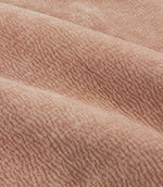 Close-up of folded Heath Washed Velvet fabric in soft terracotta-pink Cotta, showing its plush pile and gently rippled woven texture.
