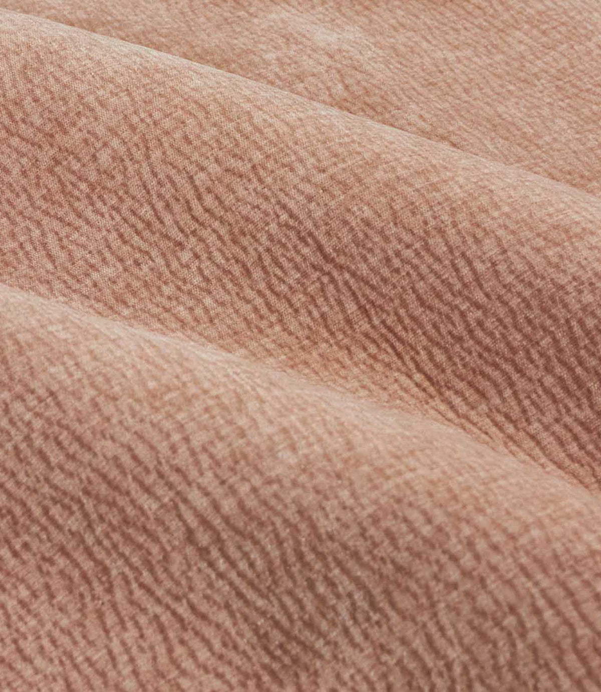 Close-up of folded Heath Washed Velvet fabric in soft terracotta-pink Cotta, showing its plush pile and gently rippled woven texture.