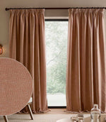 Heath Washed Velvet pencil pleat curtains in soft terracotta-pink Cotta frame a large window, with an inset close-up of the textured fabric.