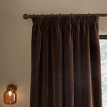 Espresso brown washed velvet pencil pleat curtain hanging from a dark wooden curtain pole, showing the gathered heading and textured finish.