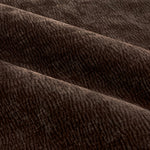 Close-up of espresso brown washed velvet curtain fabric arranged in soft folds, highlighting its rich texture, subtle ribbed pattern and plush finish.