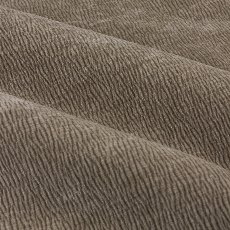 Close-up of greige washed velvet curtain fabric arranged in soft folds, highlighting its plush surface, fine ribbed texture and subtle tonal variation.