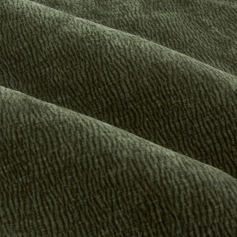 Close-up of olive green washed velvet curtain fabric arranged in soft folds, highlighting its plush surface, fine rippled texture and subtle tonal variation.