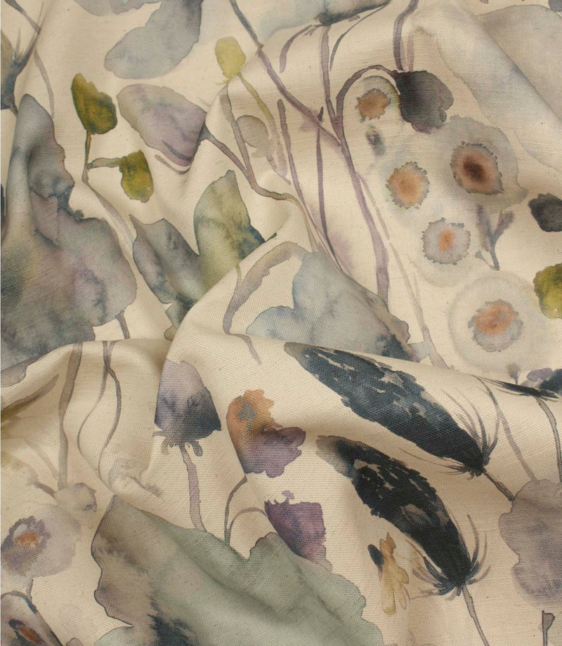 Hibberia Crocus fabric draped in soft folds, displaying the contemporary floral print in muted blue, green, lilac and cream shades.
