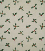 Holly and Berry Stone Christmas fabric featuring a repeating pattern of dark green holly leaves and red berries on a warm stone neutral background.