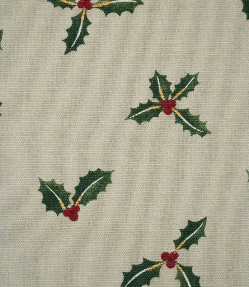 Close-up of Holly and Berry Stone fabric showing festive green holly leaves, red berries and fine gold detailing on a textured neutral woven ground.