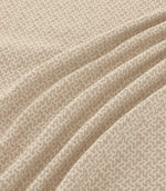 Horton Gull beige and cream geometric fabric draped in gentle folds, highlighting its subtle pattern, woven texture and natural-looking drape.