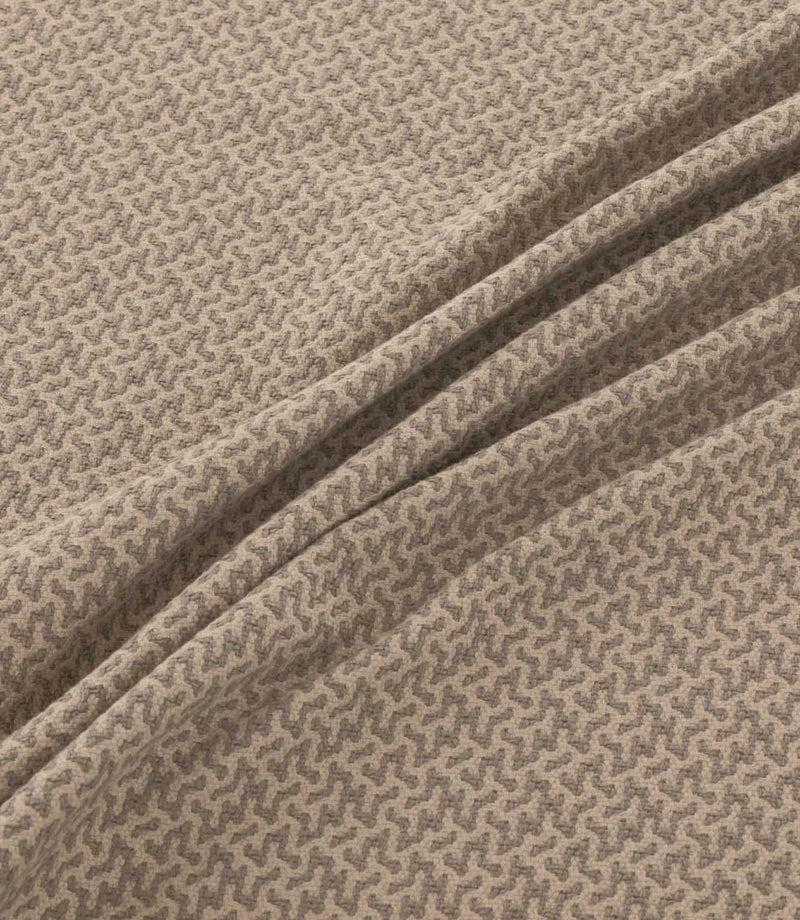 Horton Rockport grey-brown and beige geometric fabric draped in soft folds, highlighting its intricate repeating design and woven texture.