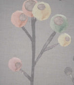 Close-up of Ichiyo fabric showing abstract circular flowers in blush pink, pale yellow and mint green on fine grey branches, with a visible woven texture.