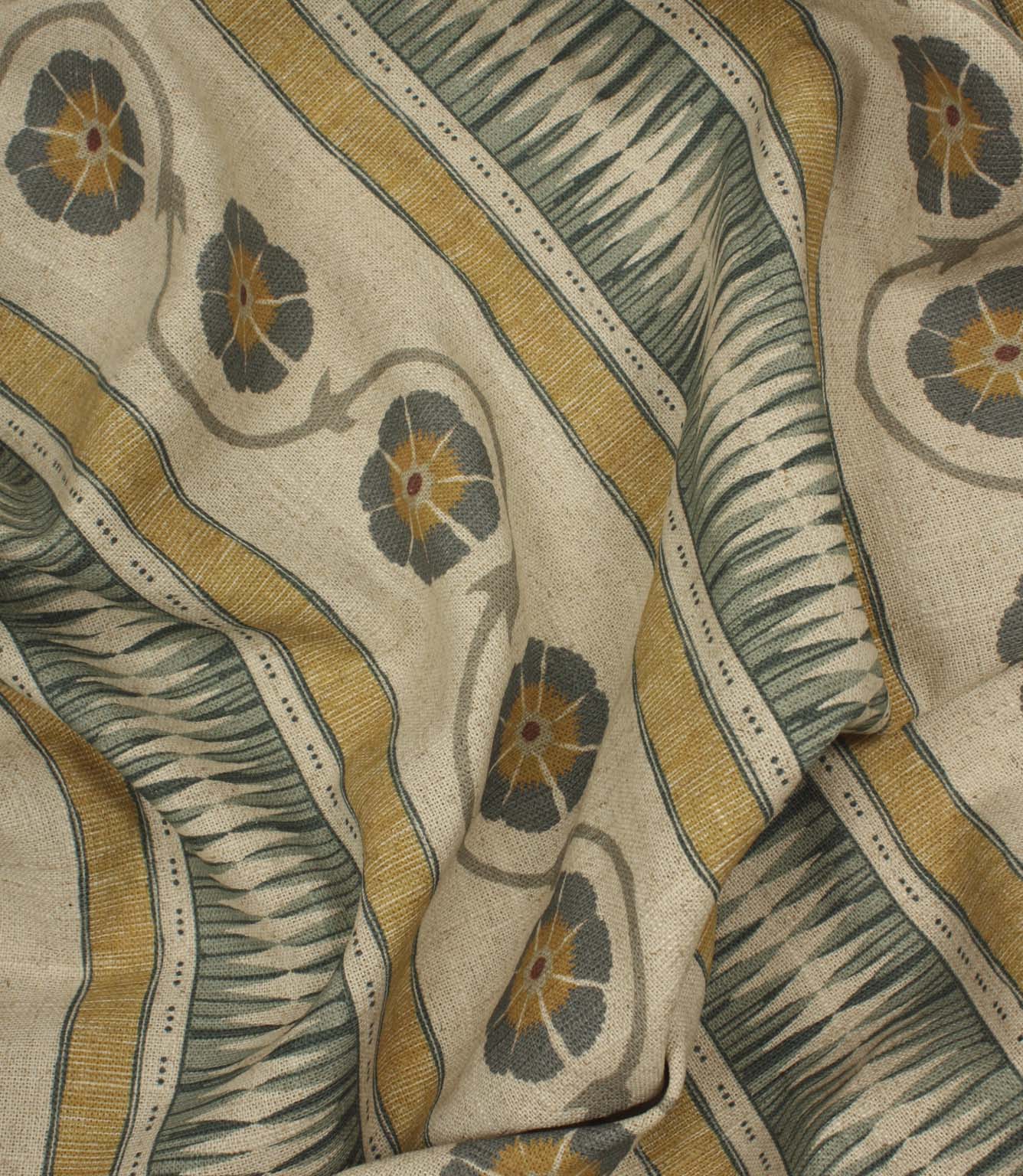 Draped woven-look fabric with stylised floral trails and layered stripe patterns in ochre, blue-grey, and natural linen shades.