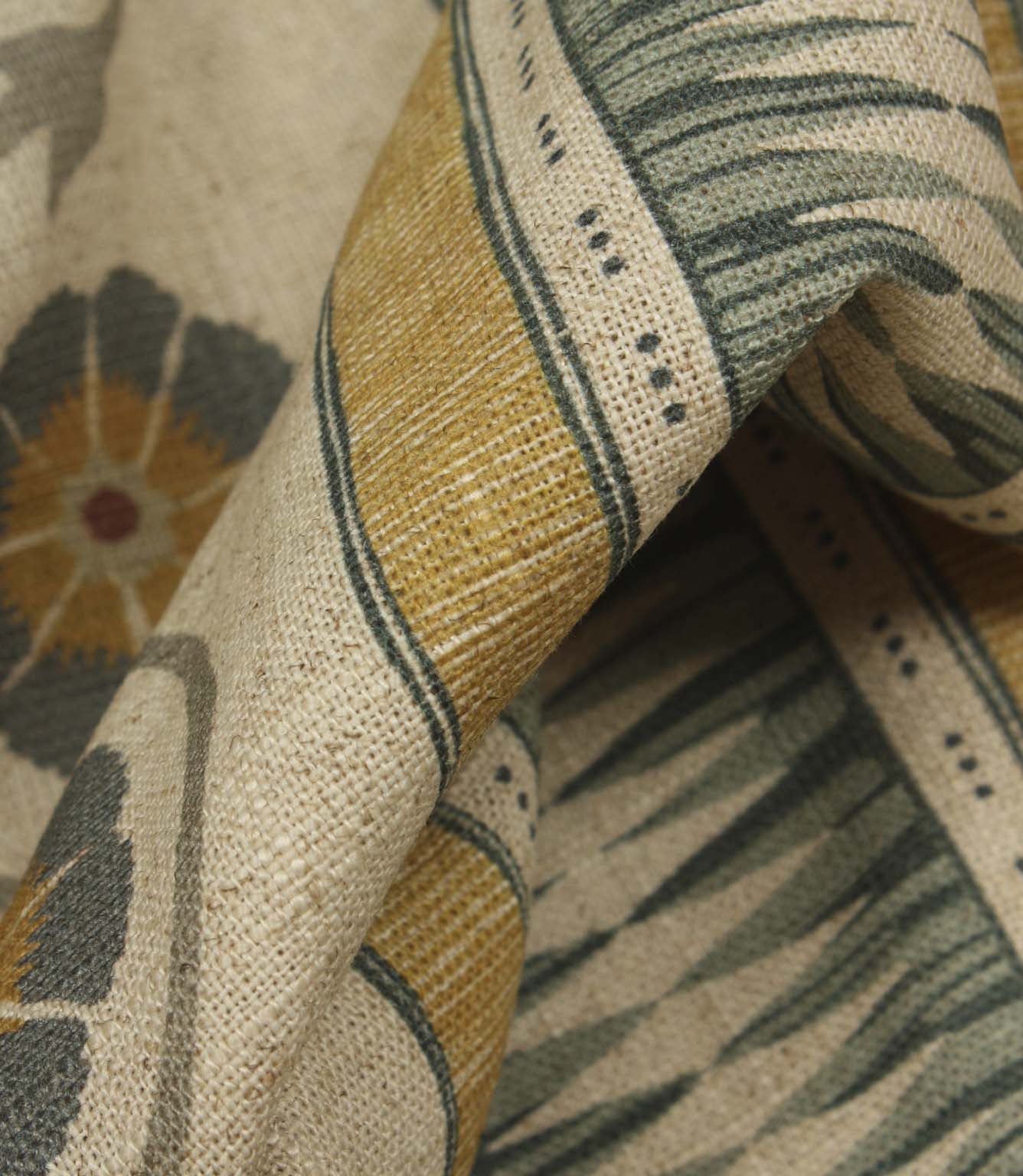 Detailed close-up of textured stripe fabric showing woven-effect bands and floral motifs with a soft rustic finish.