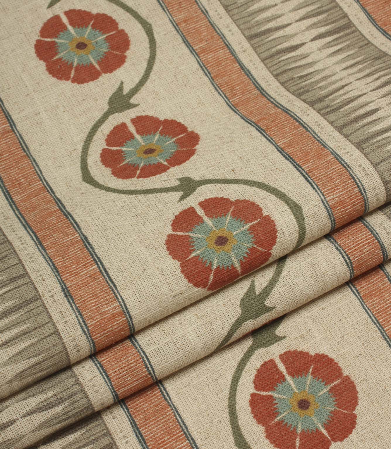 Folded striped floral fabric with flowing vine details and textured woven-style stripes in coral and taupe tones.