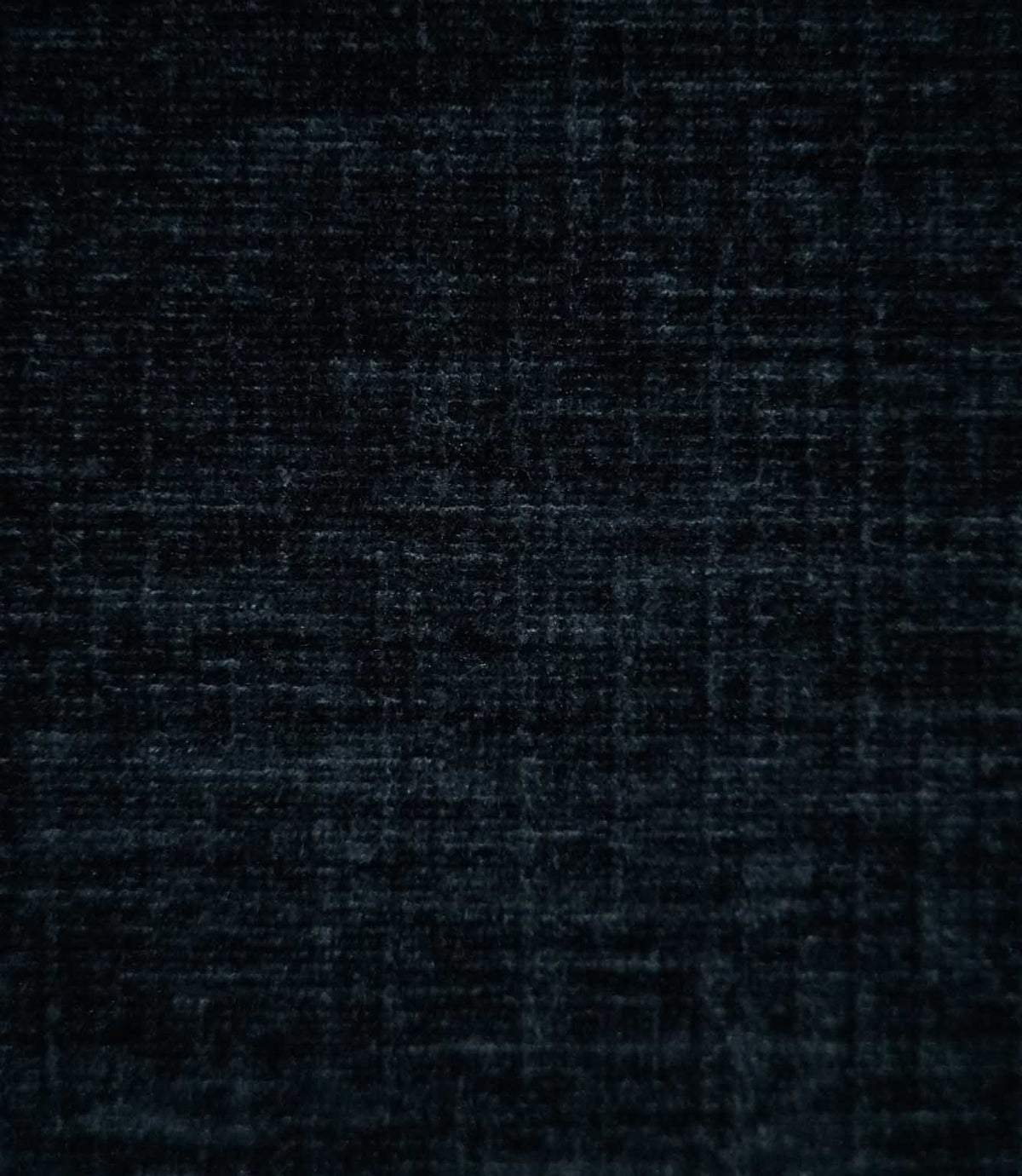 Insernia Velvet Night fabric in a deep charcoal navy shade, featuring a subtle mottled texture with fine horizontal and vertical variations across its soft velvet surface.