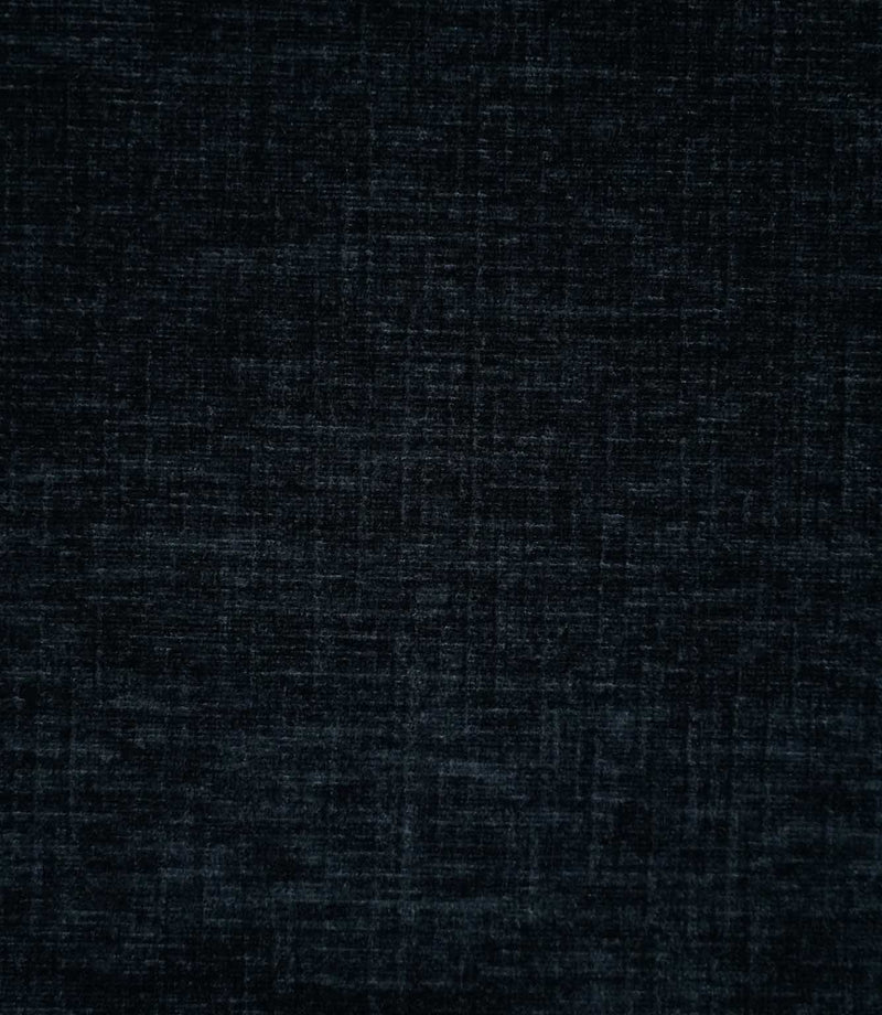 Close-up of Insernia Velvet Night plain fabric, showing its dark navy and charcoal tones with a softly distressed, crosshatched texture and subtle variations in the velvet pile.
