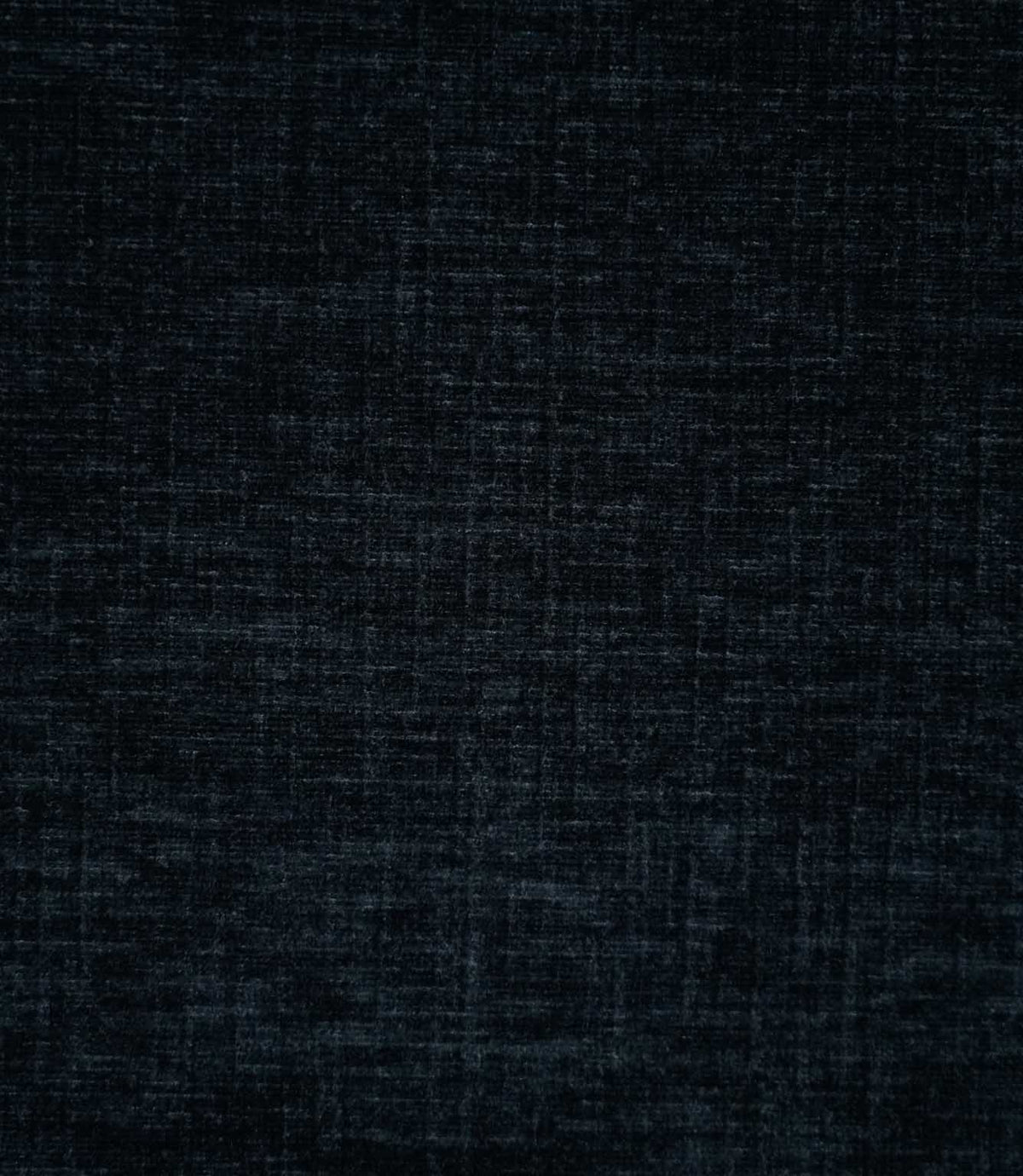 Close-up of Insernia Velvet Night plain fabric, showing its dark navy and charcoal tones with a softly distressed, crosshatched texture and subtle variations in the velvet pile.