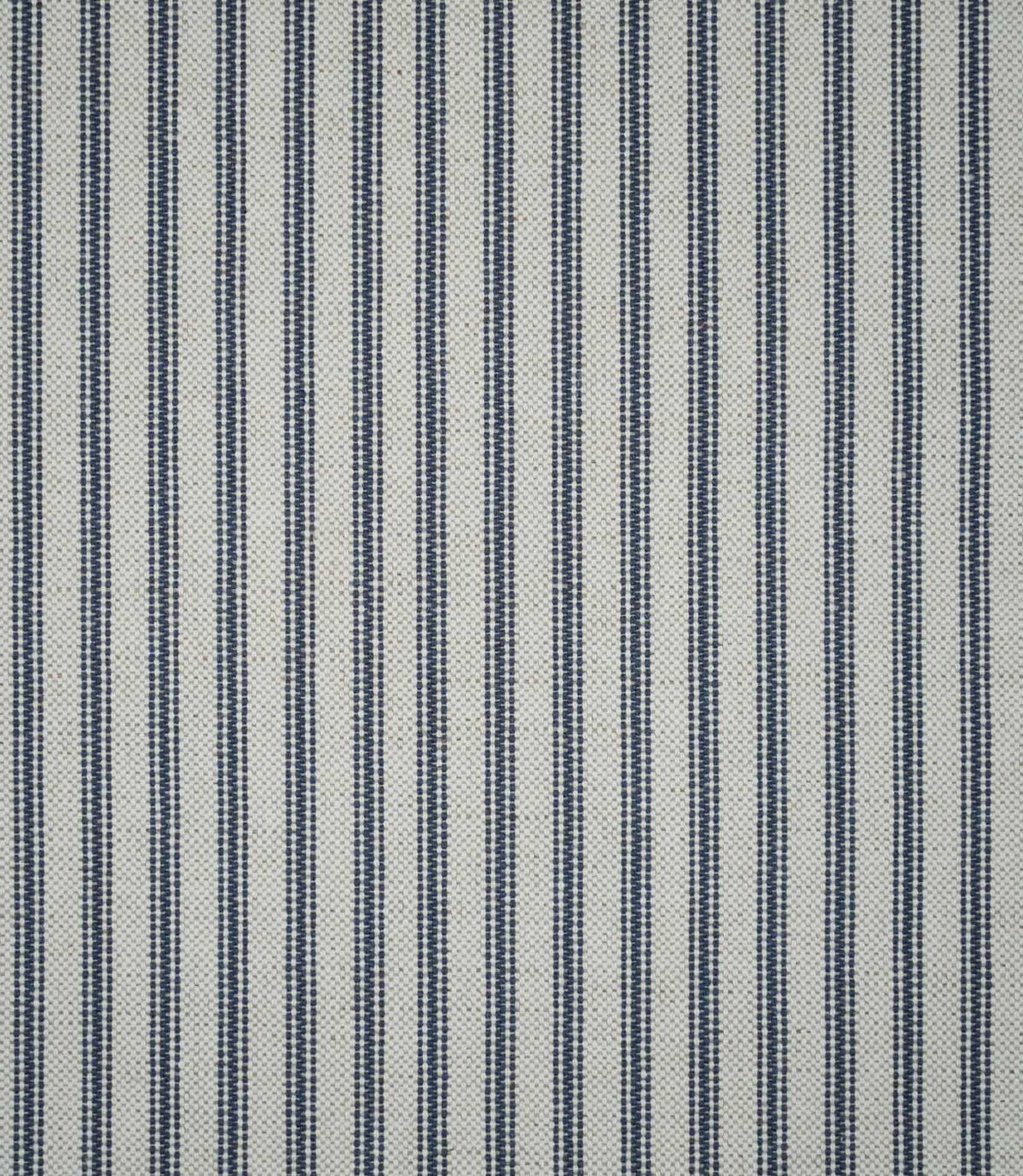 Full view of blue ticking stripe fabric featuring repeating narrow navy blue stripes woven into a natural cream textured ground.