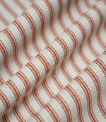Draped Linen Ticking Burnt Orange fabric with soft folds highlighting the repeating orange ticking stripes and textured woven finish.