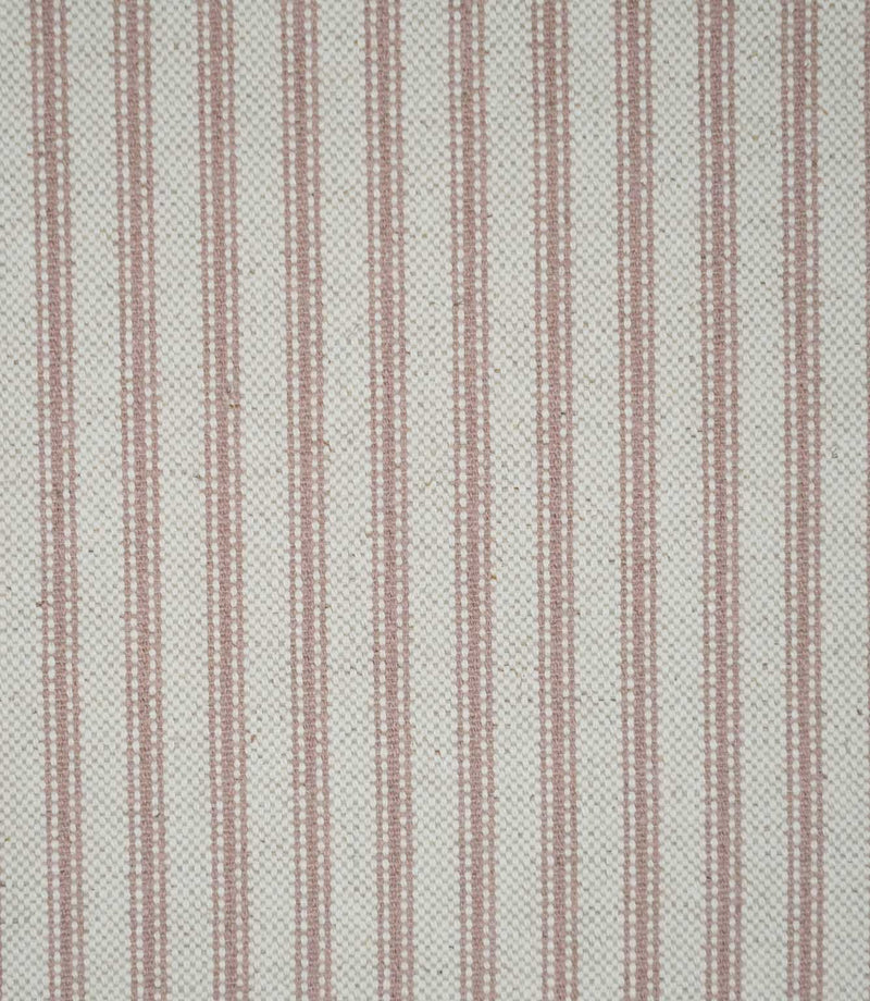 Close-up of pink ticking stripe fabric featuring fine dusty pink woven stripes on a soft cream background, highlighting the textured weave and classic striped design.