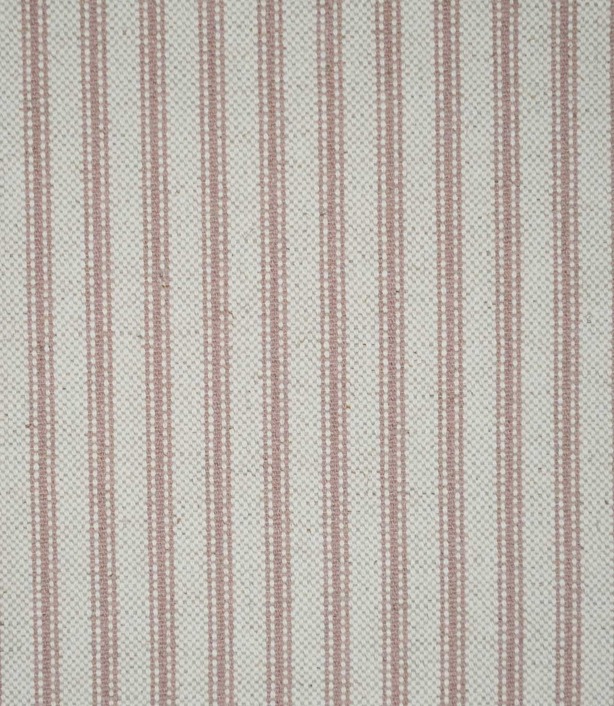 Close-up of pink ticking stripe fabric featuring fine dusty pink woven stripes on a soft cream background, highlighting the textured weave and classic striped design.