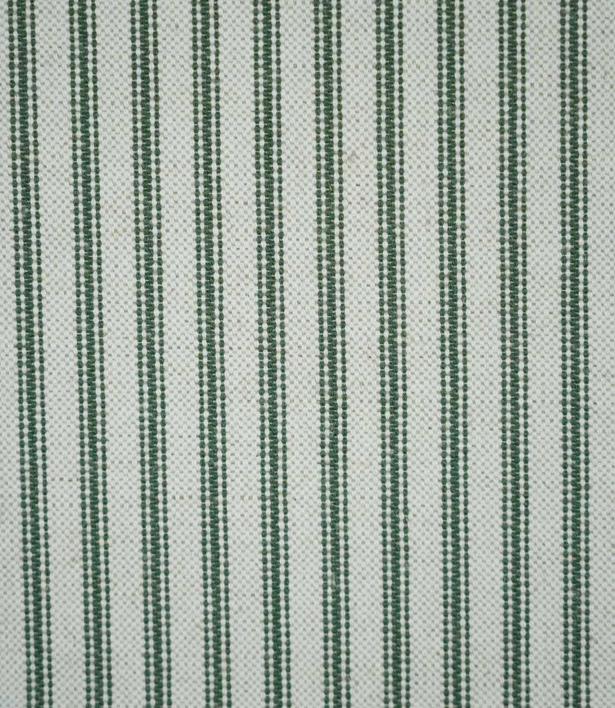 Close-up of sap green ticking stripe fabric with narrow woven green stripes on a natural cream background, showing the textured weave and classic striped design.