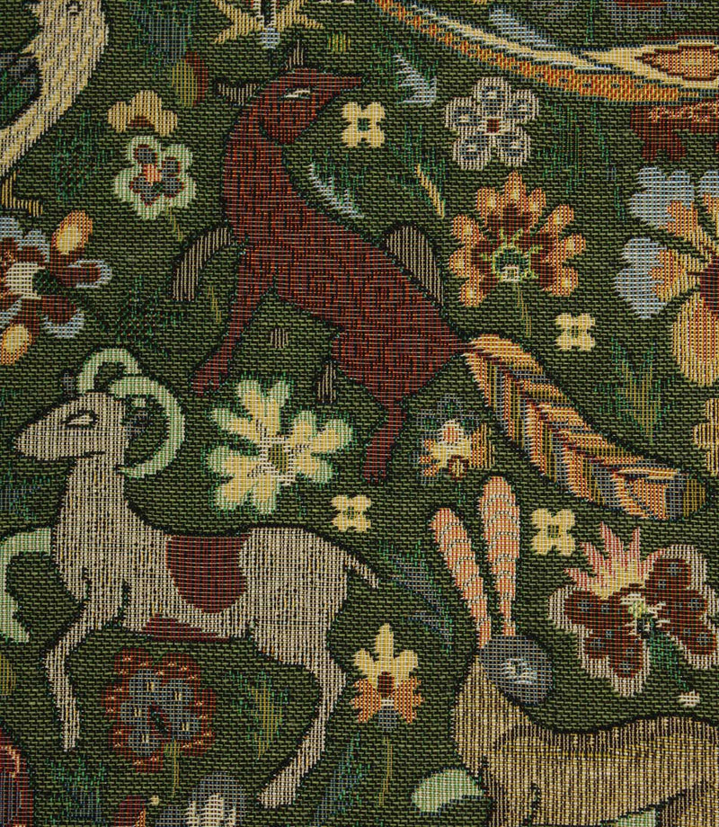 Close-up of a tapestry fabric with floral and animal patterns, including deer and goats.
