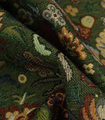 Close-up of a patterned tapestry fabric with green and brown colors