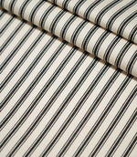 JF Ticking Black striped fabric laid flat and folded, showing the repeating black ticking stripe design and textured cream woven ground.