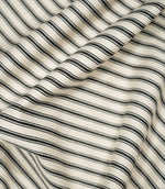 JF Ticking Black fabric draped in soft folds, highlighting the natural drape, classic black ticking stripes and subtle herringbone texture.