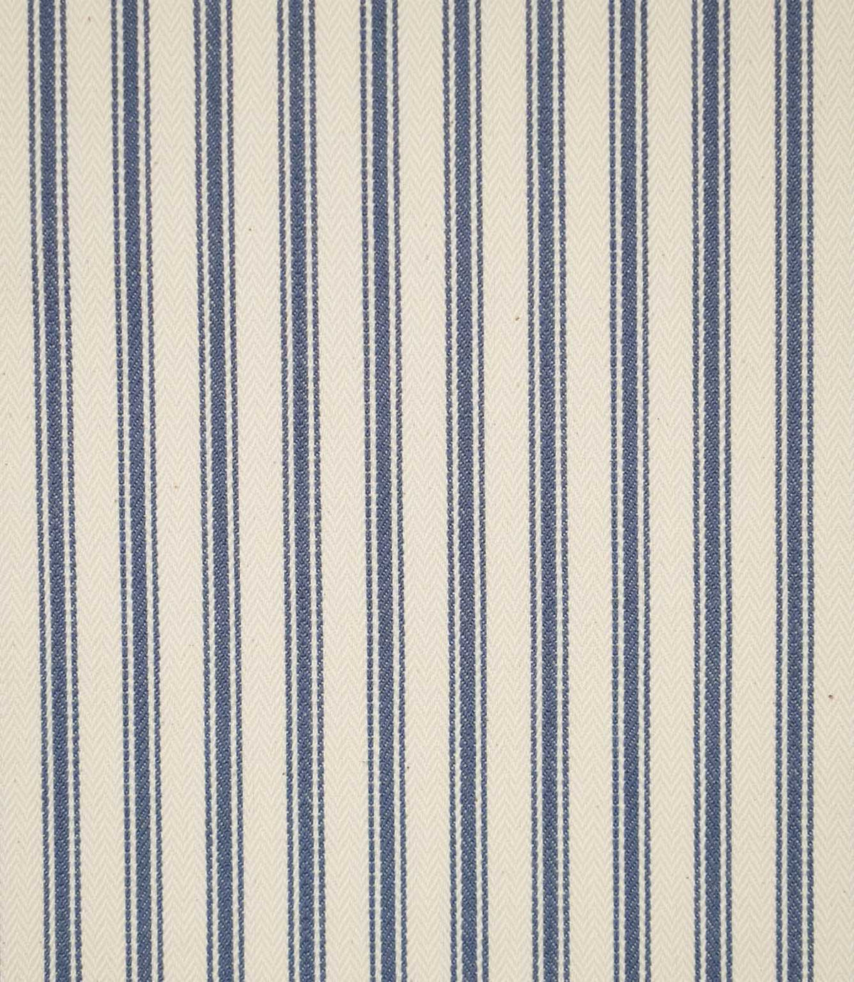 JF Ticking Blue fabric featuring classic vertical blue ticking stripes on a warm cream background with a subtle herringbone woven texture.