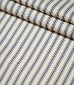 JF Ticking Blue striped fabric laid flat and neatly folded, showing the repeating blue ticking stripe design and textured cream weave.