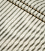 Layered folds of JF Ticking Forest striped fabric, displaying the repeating forest green ticking stripes and subtle ivory woven texture.