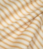 JF Ticking Ochre fabric draped in soft folds, highlighting the repeating ochre ticking stripes, cream background and natural movement of the fabric.