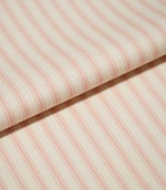 Close-up of folded JF Ticking Pink fabric showing soft pink ticking stripes and the fine herringbone texture of the cream woven ground.