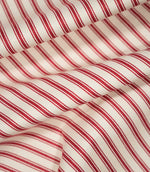 JF Ticking Red fabric draped in soft folds, highlighting the classic red ticking stripe design, woven texture and natural drape of the fabric.