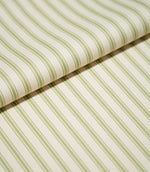Close-up of folded JF Ticking Sage Green fabric showing the repeating sage green ticking stripes and fine herringbone texture of the cream background.