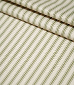 JF Ticking Sap Green striped fabric arranged in neat folds, showing the evenly spaced olive green stripes and textured cream woven ground.