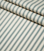 JF Ticking Teal fabric arranged in layered folds, showing the repeating dark teal ticking stripe pattern across the cream woven background.