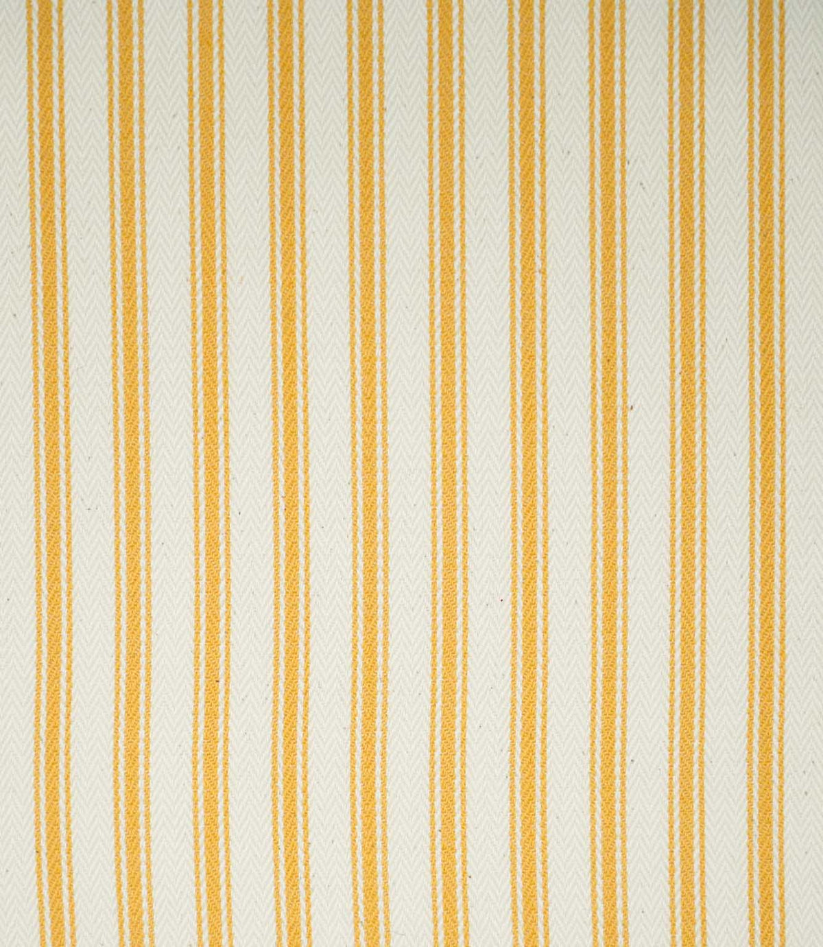 Close-up of JF Ticking Turmeric fabric featuring warm golden yellow vertical ticking stripes on a natural cream background, with a subtle herringbone weave adding texture.