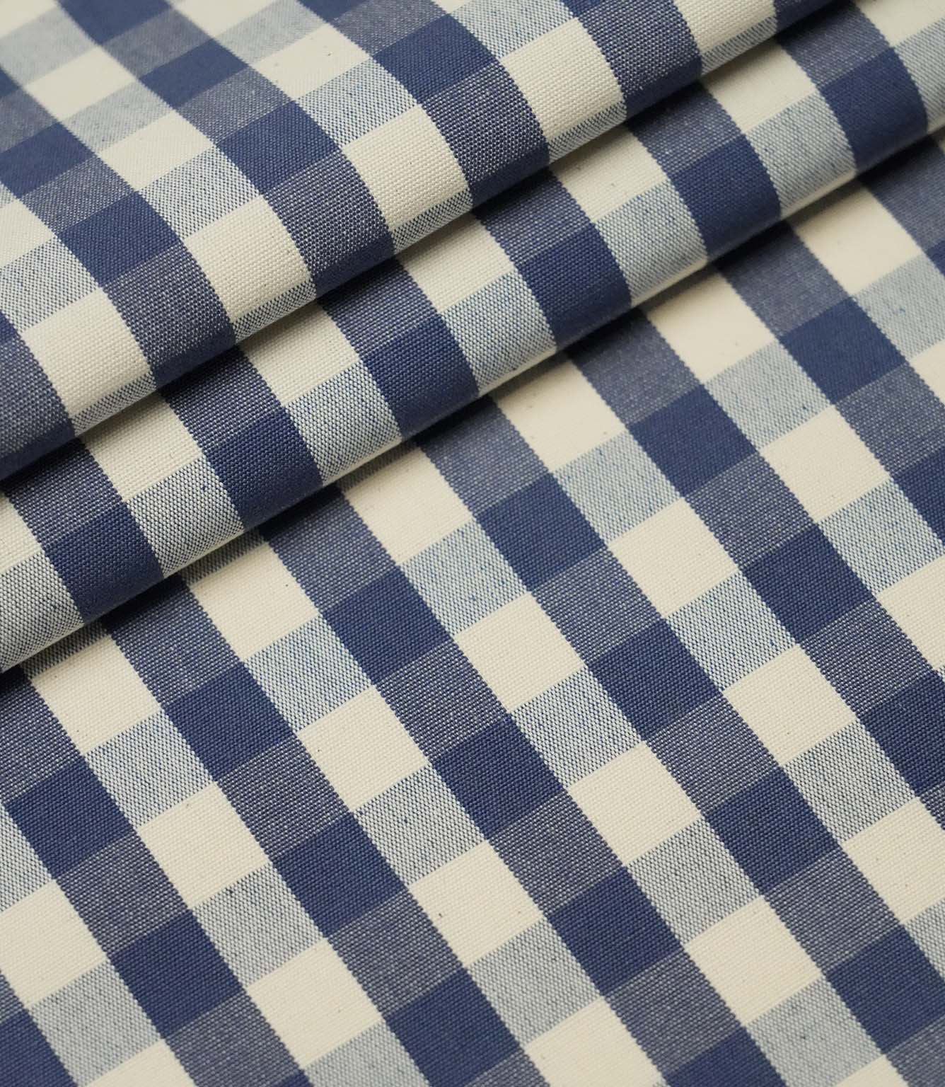 Folded blue and ivory small gingham check fabric highlighting the crisp woven pattern and premium quality finish.