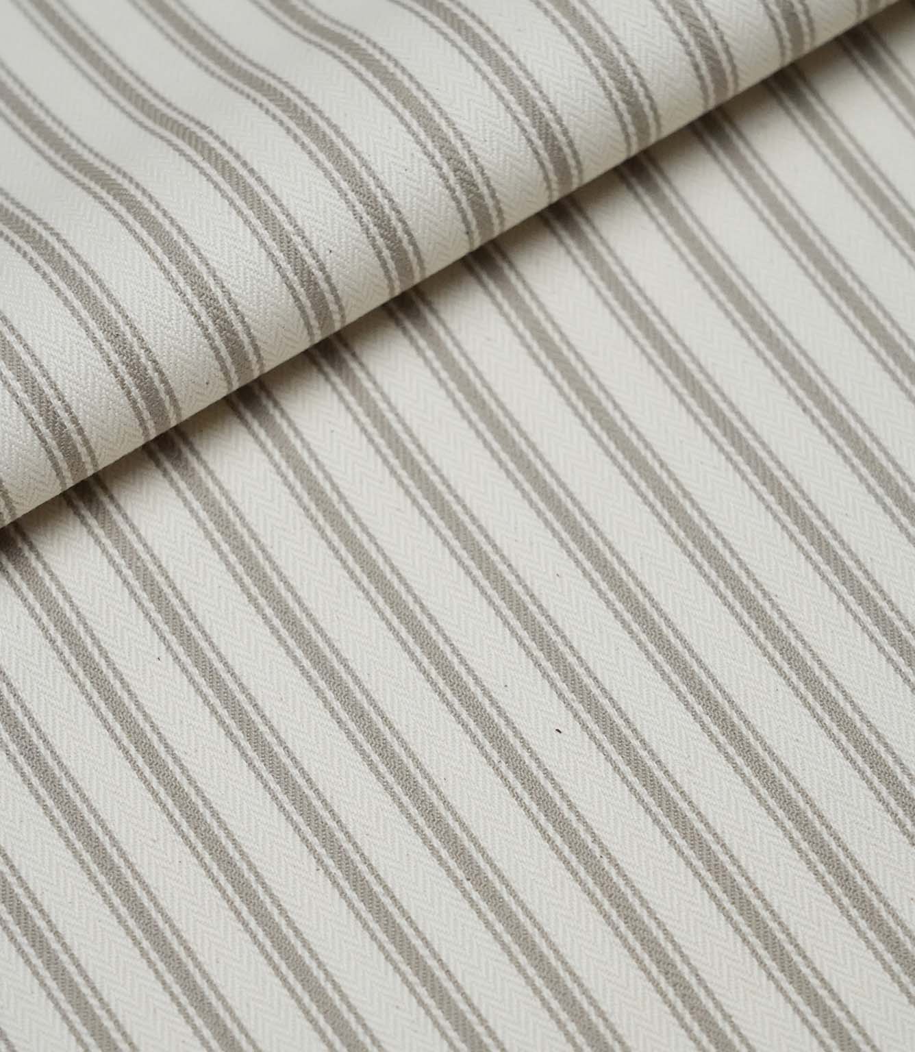 Folded beige ticking stripe fabric showcasing the classic striped design, woven texture and premium quality finish.